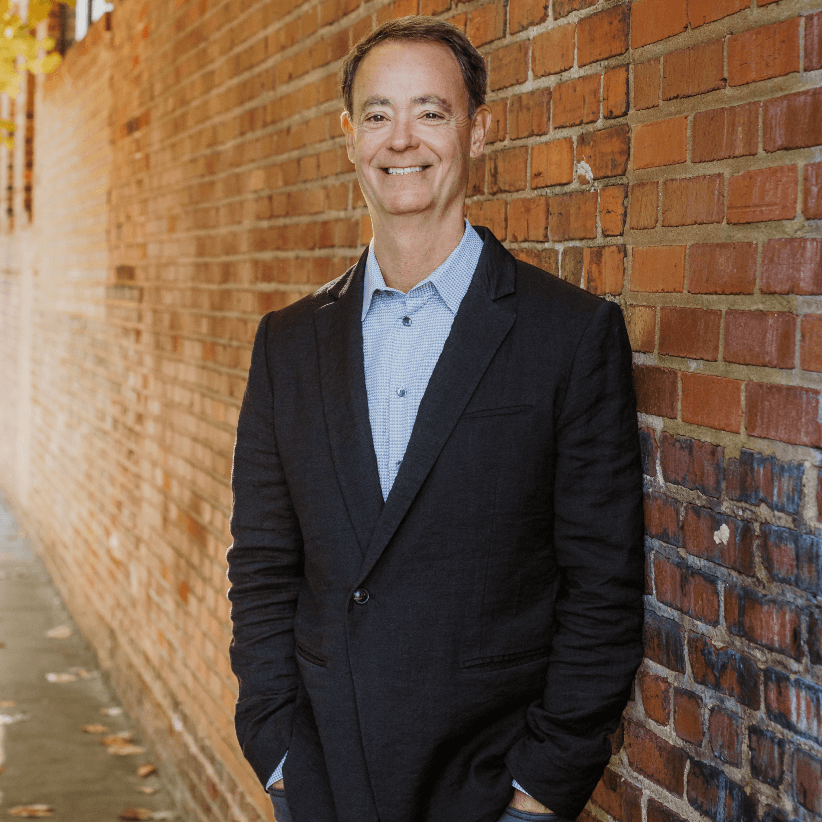 An image of Jerry Parker, founder of Chesapeake Capital, standing in front of a brick wall